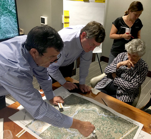 Family members reviewing property map of the Shield Ranch. 